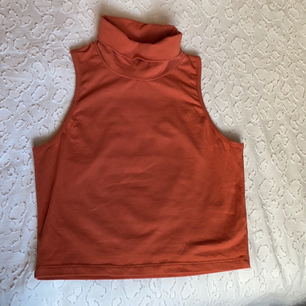 Sleeveless crop top with fold over collar